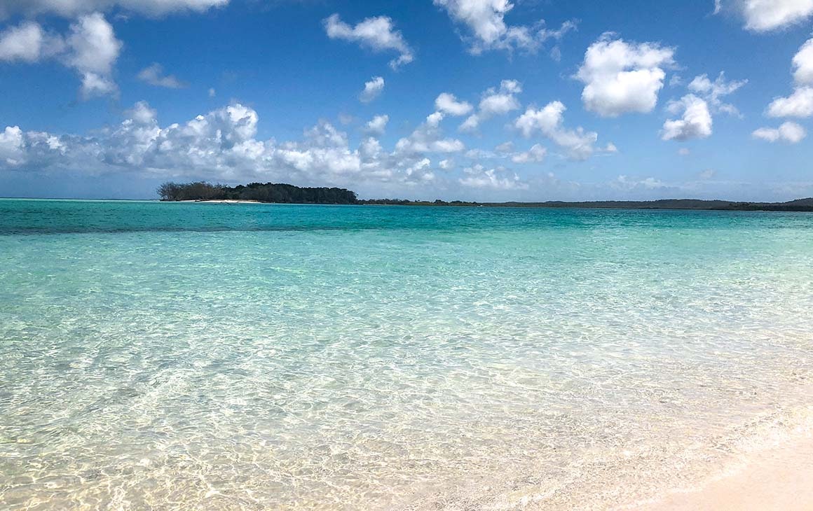 Crystal clear water of Fraser Island meets a white sand beach